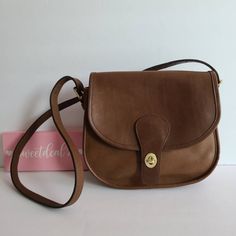 "Vtg classic coach Saddlery Bag Soft and supple British Tan leather with brass hardware Roomy interior with zip pocket, outer slip pocket covered by a flap and secured with a turnlock. Adjustable strap with a 14 1/2\"-21\" drop Measures: 9 1/2\"L, 9\"H, 4\"W Made in New York City, USA #922-6736 Flaws: faint stains on top of bag that did not remove with a deep cleaning. Cleaned, conditioned and ready to wear! More vtg coach styles/colors available Questions? Just ask G80" Bag Obsession, Vintage Coach Bags, Purses Designer, Coach Leather, Vintage Coach, Tiffany Blue, Classic Leather, Vintage Bags, Flap Bag