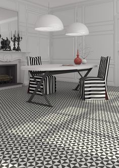 a dining room with black and white patterned flooring, two lamps above the table