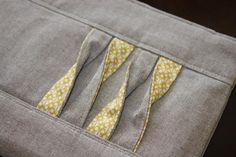 a piece of fabric with yellow and white flowers on it is stitched into the pocket