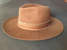 "Firm wide brim brown felt Fedora Cowboy Hat ... bohemian / hippie style... purchased at Abiquiu Inn / Georgia O'keefe welcome center, Abiquiu, New Mexico...  in excellent like new condition, worn only once... Western / Southwestern Nomad... with leather & frayed band finish... large, 59cm From hat maker's listing (along with the last 3 photos) : This Felt Fedora Hat is the rancher style hat of your dreams. Featuring a frayed texture band with a leather accent strip and a wide brim, it is guaran Brown Leather Fedora For Fall, Rustic Brown Fedora With Curved Brim, Brown Leather Fedora For Winter, Adjustable Brown Fur Felt Fedora, Bohemian Fur Felt Fedora Hat, Bohemian Fur Felt Fedora, Bohemian Fur Felt Hat With Flat Brim, Artisan Hats For Ranch In Fall, Rustic Brown Brimmed Fedora