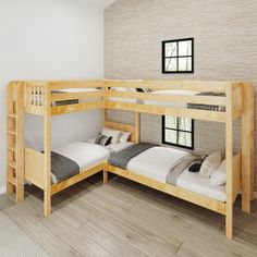 two bunk beds in a room with wood flooring and white walls, one has a ladder leading to the second bed