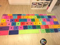 a multicolored keyboard is on the floor in a child's playroom