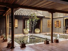 an indoor courtyard with potted plants and water features