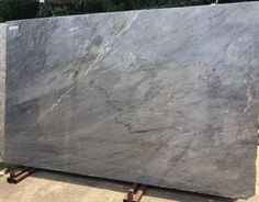 a large gray marble slab sitting on top of a wooden pallet