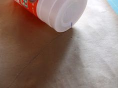 an orange and white cup sitting on top of a counter next to a blue pool