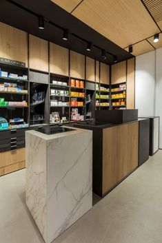 an empty pharmacy room with marble counter tops