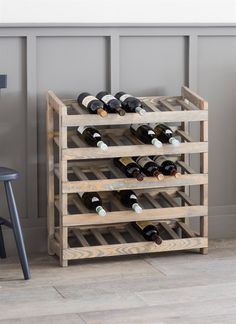 a wooden wine rack filled with lots of bottles