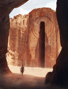 two people are walking through the desert near large rocks and an arch in the rock