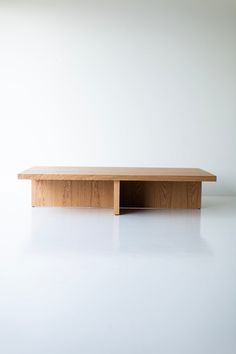 a wooden table sitting on top of a white floor