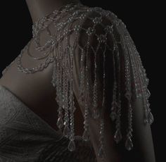 the back of a woman's dress with beads on it