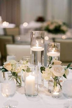 Transform Your Wedding Tables with Our Elegant Glass Candle Cylinder Vases Versatile Set: This exclusive set includes 15 clear glass cylinder vases in three different heights (4, 8, and 12 inches), all with a uniform width of 3.5 inches, perfect for creating dynamic and visually captivating centerpieces. Premium Quality Glass: Each vase is crafted from high-quality clear glass, ensuring durability while offering a crystal-clear display for candles, flowers, or decorative elements you choose to s Candles Centrepiece Wedding, Civil Wedding Centerpieces, 3 Candle Centerpiece, Candle And White Flower Centerpiece, Candle Floral Centerpieces, Candles On Table Wedding, Candle Centrepiece For Wedding, Classic Centerpieces Wedding, Wedding Floating Candle Centerpieces