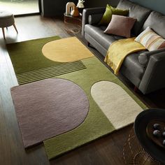 a living room with a couch and rugs on the floor