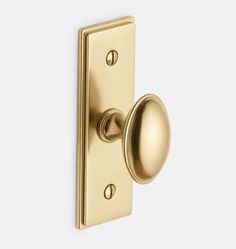 an image of a door handle on a gold door knob with a round knob in the middle