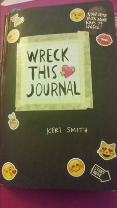 a person holding up a book with the words wreck this journal written on it