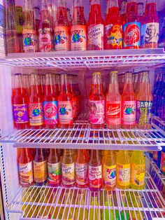 a refrigerator filled with lots of different types of drinks