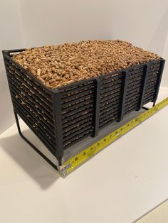 a large container filled with lots of wood chips sitting on top of a white table