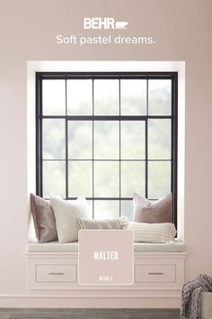 a window seat with pillows and blankets on it in front of a pink wall that says, soft pastel dreams