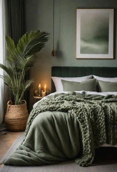 a bedroom with green walls and a large bed covered in blankets, pillows and blankets