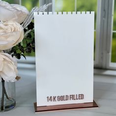 there is a card with the number one on it next to some flowers and a vase