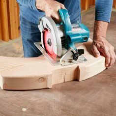 a man using a circular saw to cut wood planks with a cordless jig