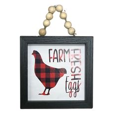 a black frame with a red and white farm fresh eggs hanging from it's side