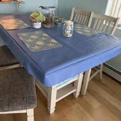 a table with two chairs and a blue cover on it