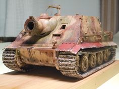 an old rusted tank sitting on top of a wooden table