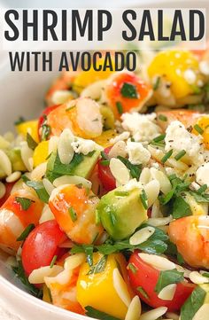 shrimp salad with avocado and feta cheese in a white bowl on a table