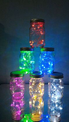 mason jars filled with colorful lights on a table