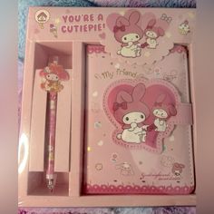 a pink hello kitty stationery set with pen and notepad in its packaging box