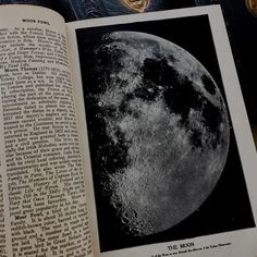 an open book with pictures of the moon on it