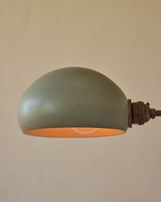 a green and orange light hanging from a ceiling