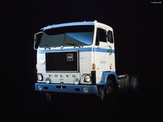 an old volvo truck parked in the dark