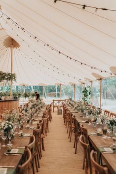 a large tent with tables and chairs set up for an event