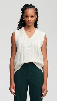 Inspired by vintage menswear, this cozy merino wool v-neck vest features a classic cable pattern. Designed to be worn alone as a top or layered over another shirt, the cropped, oversized silhouette is a daily wardrobe favorite. Complete your ensemble with wide-leg trousers, minimalist jewelry, and perfectly worn-in loafers. Vintage Menswear, Cable Pattern, Cream Style, Flare Trousers, Women's Sweaters, Oversized Silhouette, Double Breasted Blazer, Low Iron, Navy Stripes