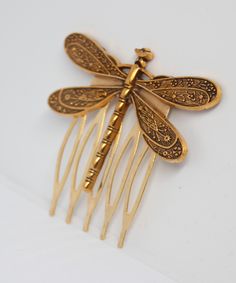 A beautiful hair comb in gold tones. The hair comb features a gold filigree dragonfly on its wings. The hair comb measures 45mm in width and 50mm in height. The dragonfly is attached to the comb using strong jewellery glue. A lovely comb perfect for any occasion, that nature themed wedding or everyday wear. Dispatched in an organza pouch. Nature Themed Wedding, Organza Pouch, Gold Filigree, Nature Themed, Themed Wedding, Hair Piece, Hair Comb, Hair Accessory, Beautiful Hair