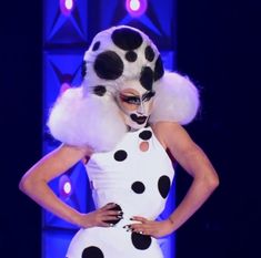 a woman in a polka dot costume on the runway