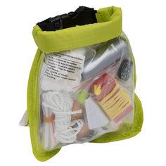 a green bag filled with assorted items on top of a white background