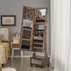 a bedroom with a large mirror and jewelry rack