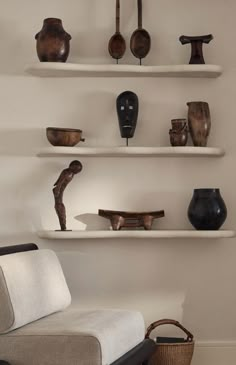 a living room filled with lots of shelves covered in vases