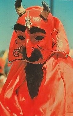 a man in an orange costume with horns on his head