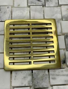 a metal grate sitting on top of a tiled floor