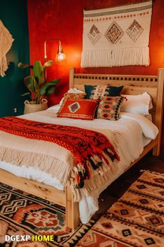 Bold Boho bedroom with red walls, woven decor, and cozy textiles. Red Accent Wall, Boho Decor Ideas, Wall Macrame, Bold Boho, Patterned Rugs, Woven Decor, Bedroom Design Ideas