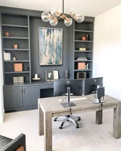 a home office with built - in bookcases and desk