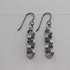 pair of silver earrings on white background