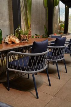 several chairs and tables with blue cushions on them