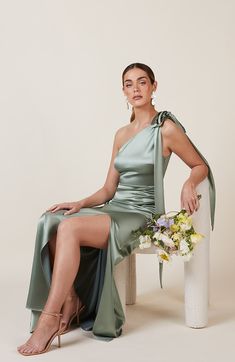 Satin one shoulder bridesmaids dress in sage green with a detachable bow. A beautiful rich mint marine green this dress is a modern and stylish option for all occasions. Silk Sage Bridesmaid Dresses, Silk Prom Dress Satin Sage Green, Sage Green Brodesmaid Dress, Dusty Sage Green Bridesmaid Dresses Silk, Green Bridesmaid Dresses Mismatched, Sage Green Bridesmaid Dresses Shona Joy, Green Wedding Guest Dresses, Mismatched Dresses, Dress Outer