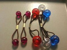 there are several different colored ear buds on the table