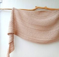 a knitted shawl hanging on a wall