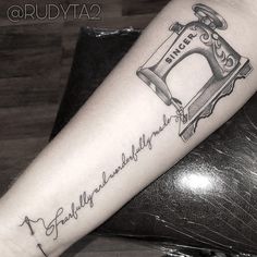 a black and white photo of a sewing machine tattoo